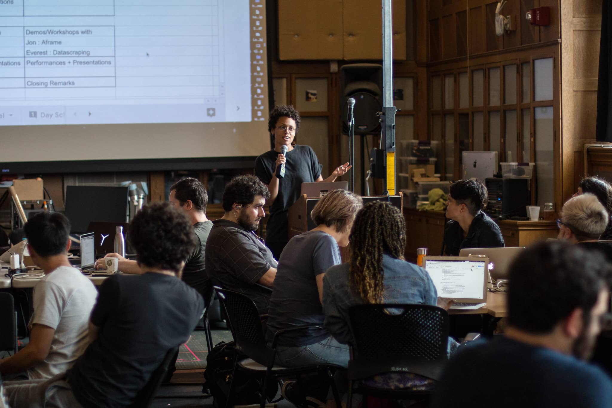 Woman giving presentation in a classroom of diverse participants